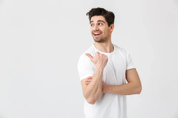 Happy young excited emotional man posing isolated over white wall background. Looking aside. — Stock Photo, Image