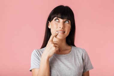 Güzel şaşırtıcı rüya kadın açık pembe arka plan duvar üzerinde izole poz.