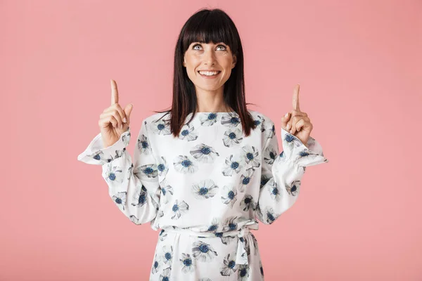 Geweldige vrouw poseren geïsoleerd over licht roze achtergrond muur wijzend. — Stockfoto