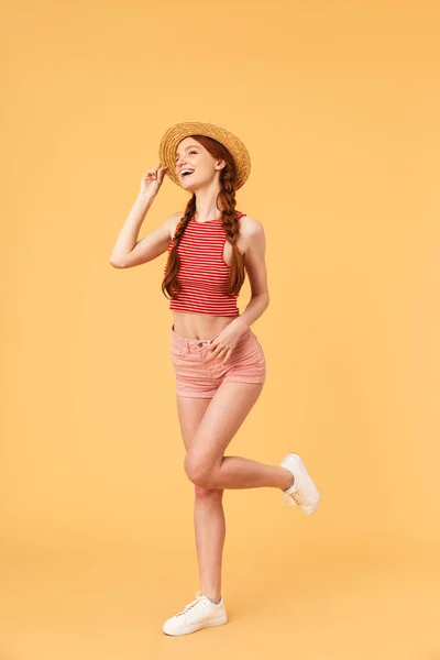 Jovem mulher ruiva bonita posando isolado sobre fundo amarelo . — Fotografia de Stock