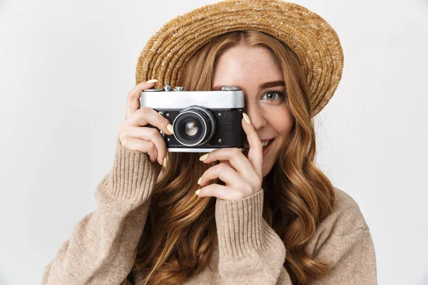 Happy pleased cute young teenage girl posing isolated over white wall background holding camera photographing. — Stock Photo, Image