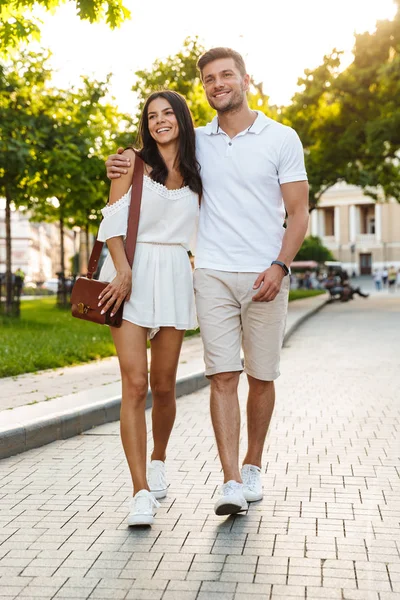 Retrato de pareja joven y complacida sonriendo y abrazándose juntos —  Fotos de Stock