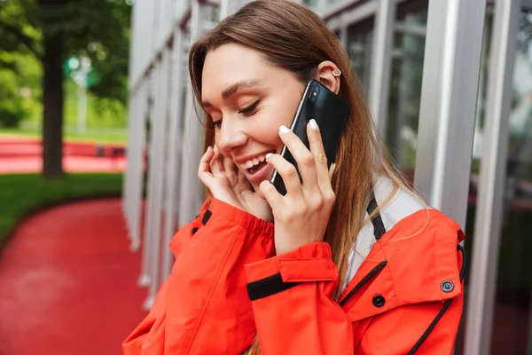 Cheerful attractive young girl wearing raincoat — Stock Photo, Image