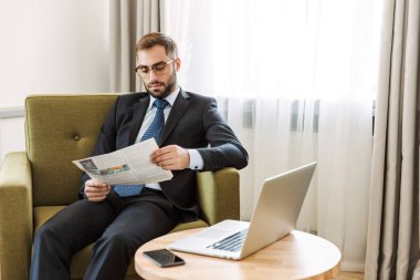 Çekici ciddi genç işadamı takım elbise giyiyor