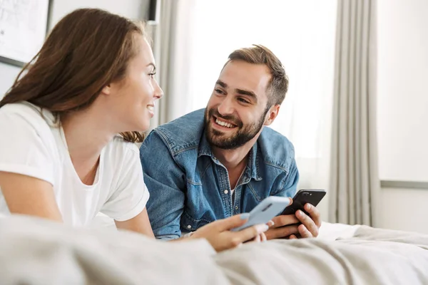 Beautiful young couple in love at home, laying in bed — Stock Photo, Image