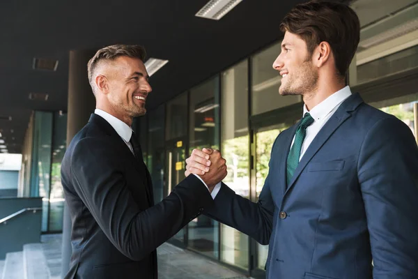 Portrait closeup of two handsome businessmen partners shaking ha — Stock Photo, Image