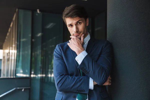 Young unshaved handsome business man outdoors at the street near business center posing. — Stock Photo, Image