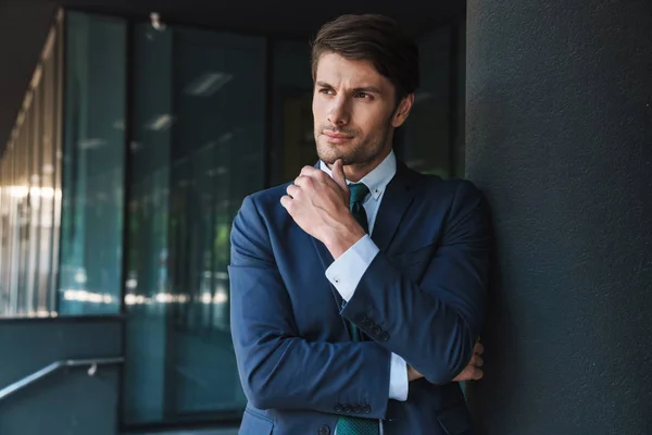 Young unshaved handsome business man outdoors at the street near business center posing. — Stock Photo, Image