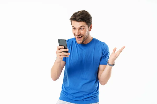 Photo of delighted man in casual t-shirt smiling and rejoicing w — Stock Photo, Image
