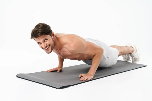 Attractive confident young shirtless sportsman working out — Stock Photo, Image