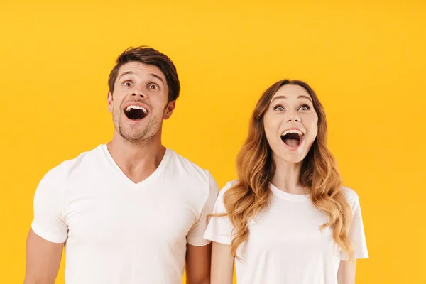 Portrait of delighted couple man and woman in basic t-shirts won — Stock Photo, Image