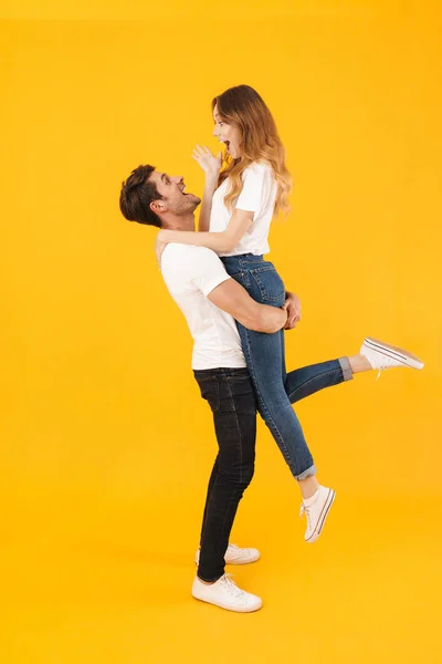 Full length portrait of lovely couple in basic t-shirts standing — Stock Photo, Image