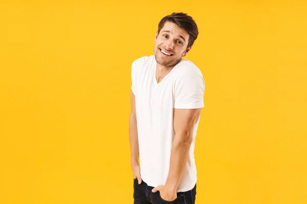 Photo of shy handsome man in basic t-shirt smiling at camera wit — Stock Photo, Image