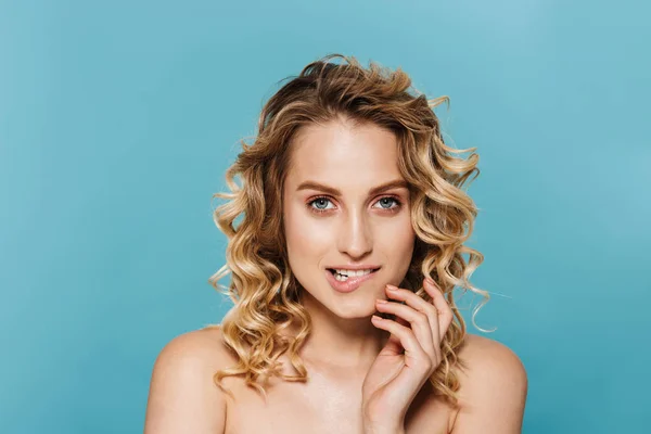 Beauty image of alluring half-naked woman with curly hair biting her lips and looking at camera — Stock Photo, Image