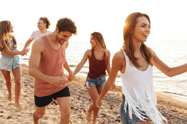 Group of cheerful happy young friends having fun