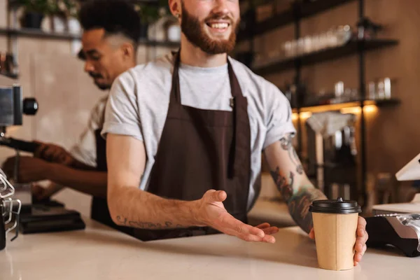 Close up of a male barista giving the order at the cafe — Stock Photo, Image