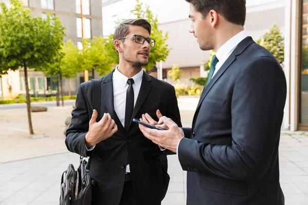 Two attractive young businessmen wearing suits — Stock Photo, Image