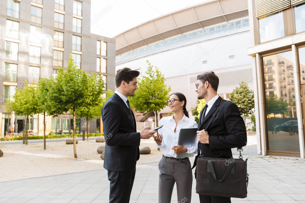 Office colleagues talking outdoors at the city streets