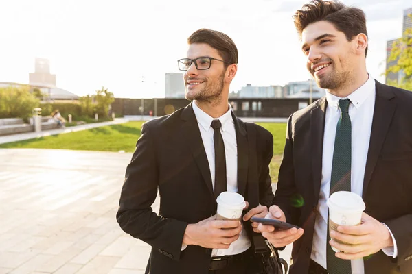Twee aantrekkelijke jonge zakenlui die kostuums dragen — Stockfoto
