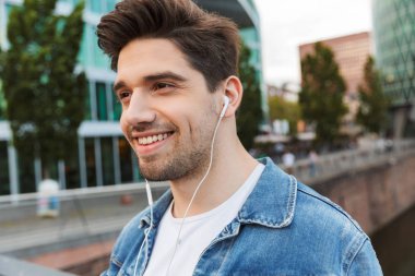 Yakışıklı genç adam rahat açık havada vakit geçirmek giymiş