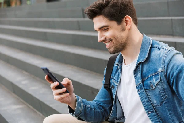 Handsome young man dressed casually spending time outdoors — Stock Photo, Image