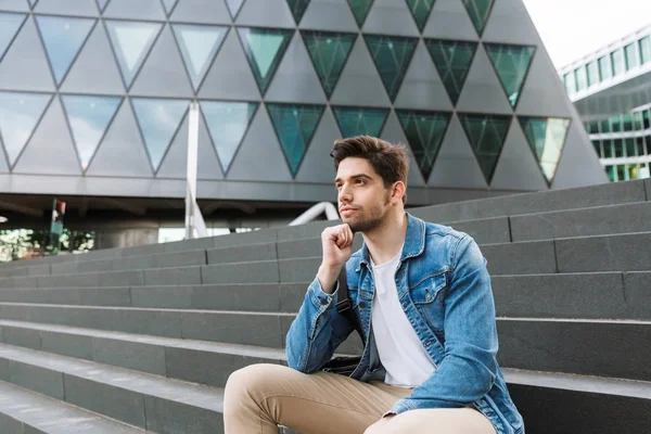 Yakışıklı genç adam rahat açık havada vakit geçirmek giymiş