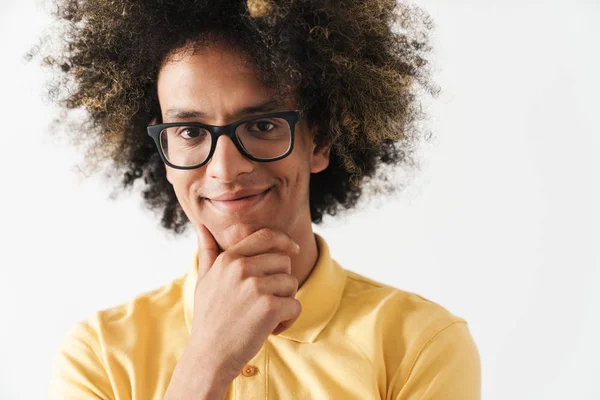 Pleased positive young curly man isolated over white background. — Stock Photo, Image