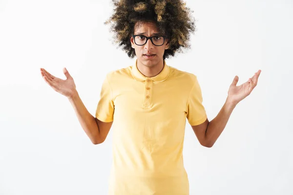 Confused young curly man isolated over white background looking camera. — Stock Photo, Image