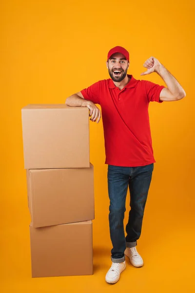 Retrato de homem de entrega alegre em dedos apontando uniforme vermelho — Fotografia de Stock