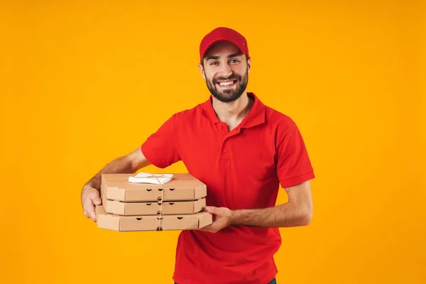 Portrait of happy delivery man in red uniform smiling and holdin — Stock Photo, Image