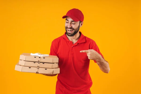 Retrato de jovem entregador de uniforme vermelho sorrindo e segurando — Fotografia de Stock