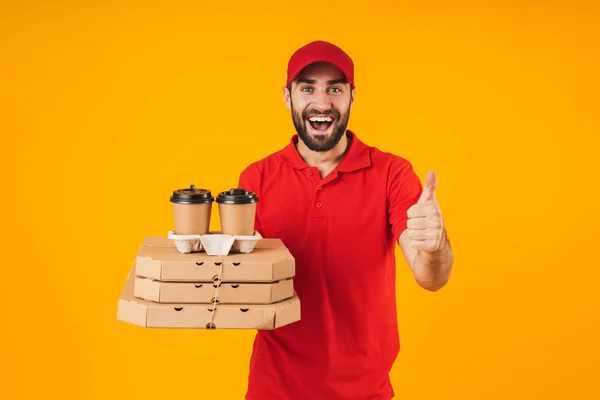 Porträt eines hübschen Zustellers in roter Uniform, der eine Pizza hält — Stockfoto