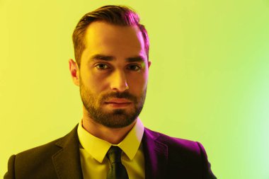 Resmi takım elbiseli konsantre genç işadamının kameraya bakan görüntü yakın çekimi