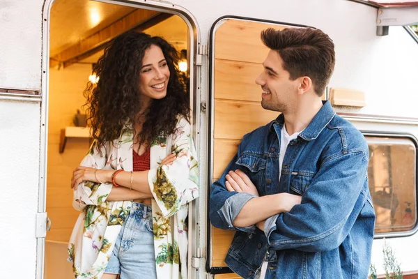 Kolları ile genç çift portresi tekerlekler açık havada evin yakınında dururken birlikte konuşurken geçti