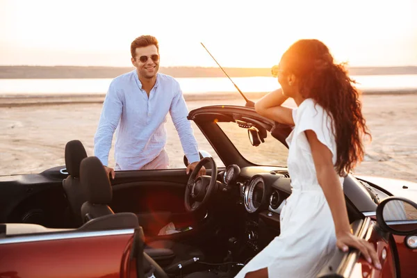 Image of gorgeous multiethnic couple smiling while standing by c — Stock Photo, Image