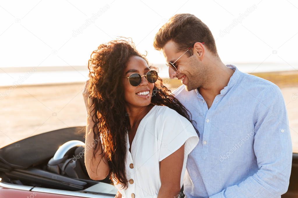 Photo of beautiful multiethnic couple hugging and smiling togeth