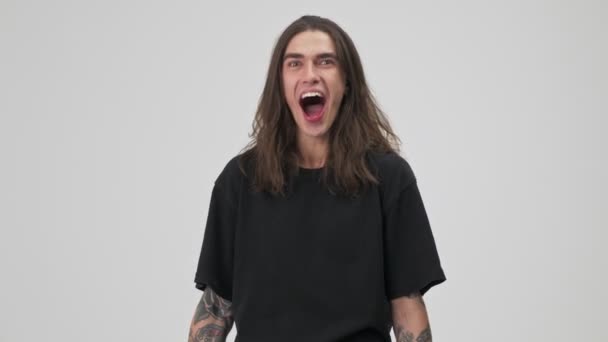 Shocked Emotional Young Tattooed Brunette Man Long Hair Black Shirt — 图库视频影像