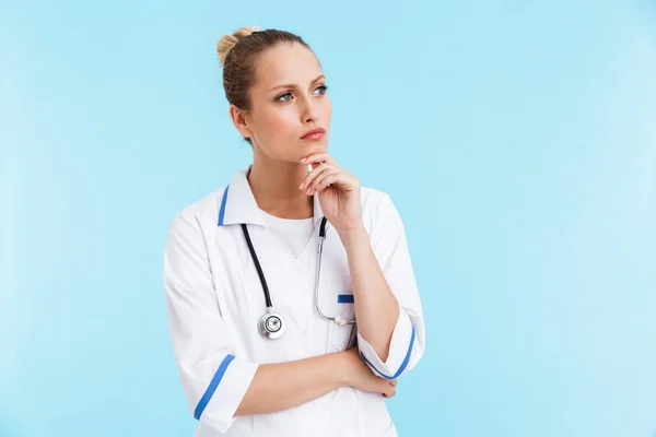 Hermosa mujer rubia médico vistiendo uniforme de pie —  Fotos de Stock