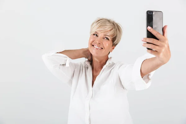 Imagem de mulher adulta alegre com cabelo loiro curto sorrindo e ta — Fotografia de Stock