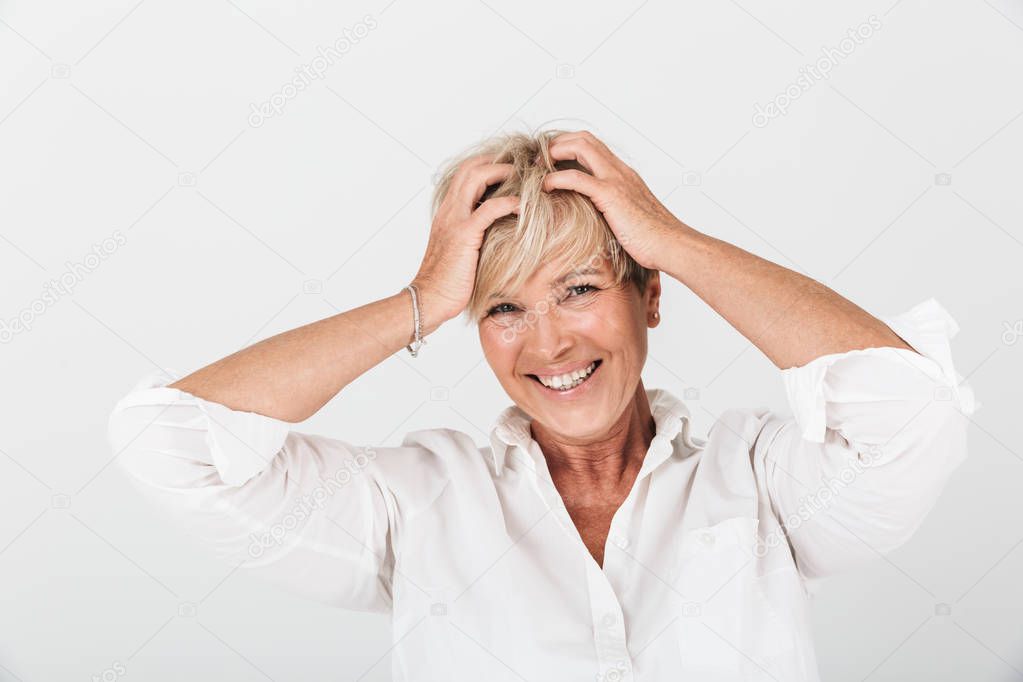 Portrait of delighted adult woman with short blond hair grabbing