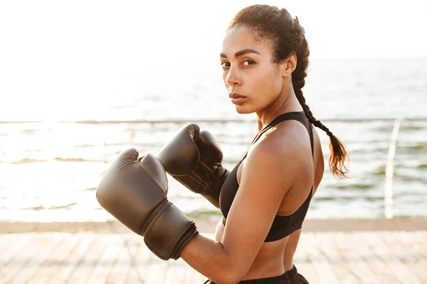 Portrait of attractive pretty woman training in boxing gloves by — Stock Photo, Image