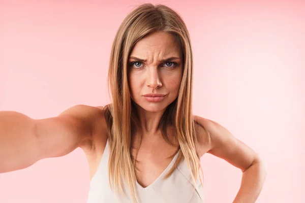 Image closeup of upset young woman frowning at camera while taking selfie photo — Zdjęcie stockowe