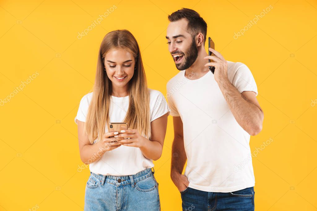 Image of happy man smiling while looking at cellphone of his girlfriend