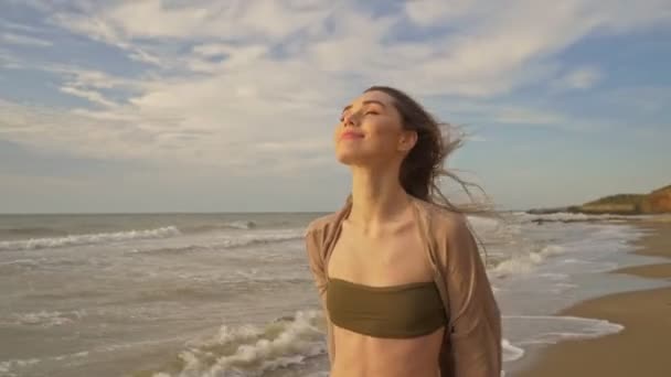 Attractive Smiling Young Woman Touching Her Fluttering Hair Enjoying Breeze — Stock Video