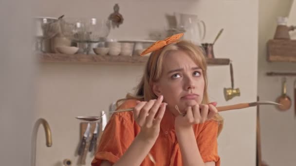 Pensive Pretty Young Blonde Woman Holding Kitchen Utensils Thinking Something — Stock Video