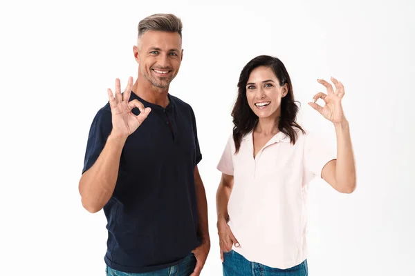 Cheerful couple wearing casual outfit standing isolated — Stock Photo, Image