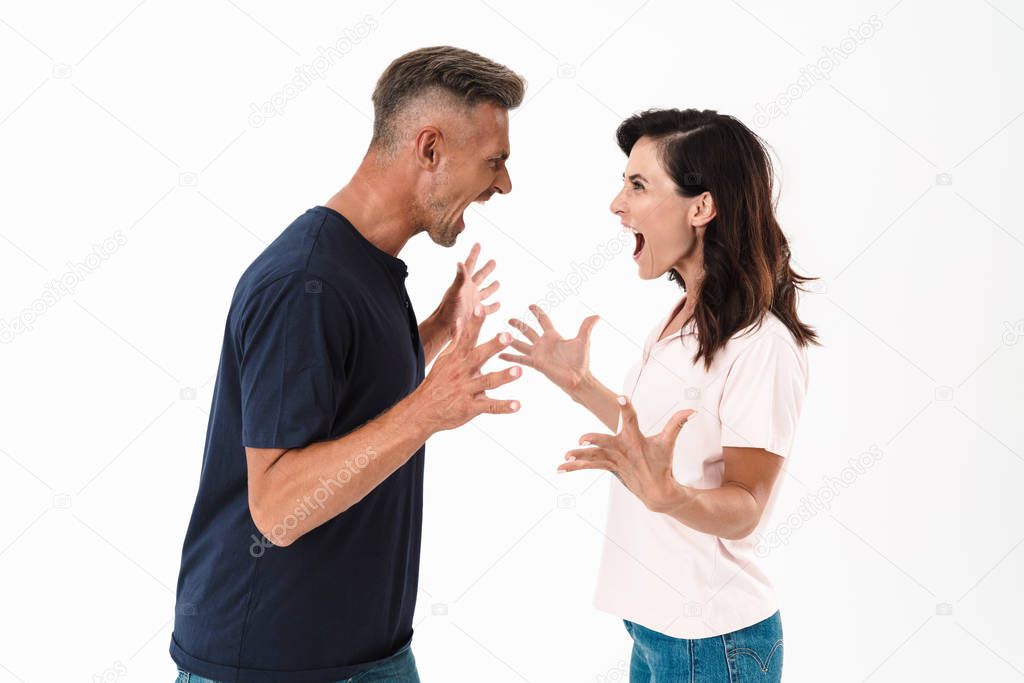 Angry couple wearing casual outfit standing isolated