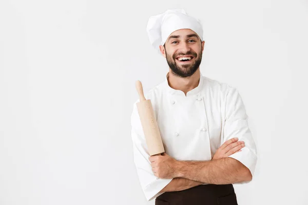 Immagine di giovane capo uomo in uniforme cuoco sorridente mentre tiene k — Foto Stock