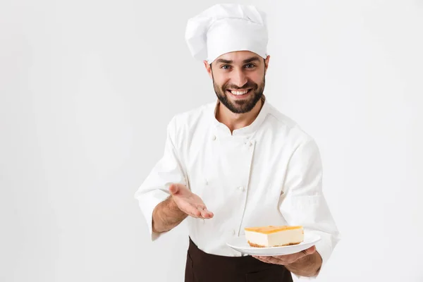 Image of joyful chief man in cook uniform smiling and holding pl — Stock Photo, Image