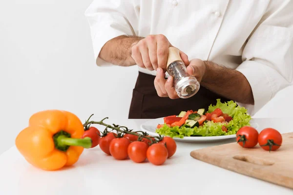 Chef aislado sobre fondo blanco de pared en cocina uniforme con verduras frescas . — Foto de Stock